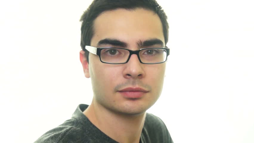 Young man with eyeglasses looking directly to the camera on white background.