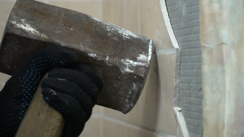 hammer smash at the tiled wall