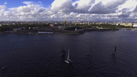 Russia, Saint-Petersburg, 04 september 2016: Aerial video regatta Extreme Sailing Series GC32 on Neva River, drone Phantom 4 DJI quadrocopter, Peter and Paul Fortress, sunny weather, clouds, cityscape