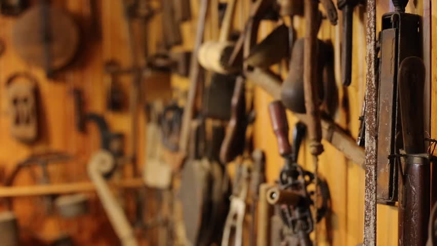 wall of antique tools pull focus deeper