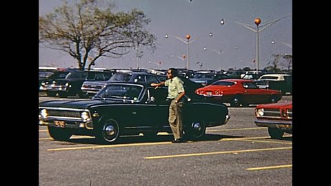 Swansea, United States of America - circa 1970: Old footage of people and vintage cars in the parking lot of Macy's Shop Fashion Clothing and Accessories, on Swansea Mall Drive in 70's.
