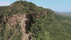 4k Drone footage of young free climber and hiker, climbing mountain cliff at sunset, South Africa. 