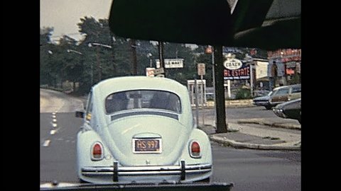 Bristol County, Massachusetts, United States of America - circa 1970: point of view tourist of driving car in Bristol County. Vintage cars on the road traffic in 70's.