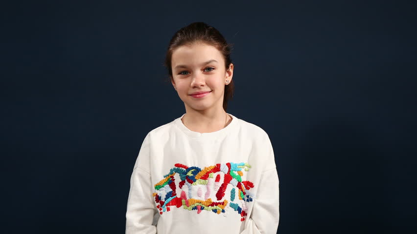 eautiful young girl claps her hands over blue background. Video resolution of 4K