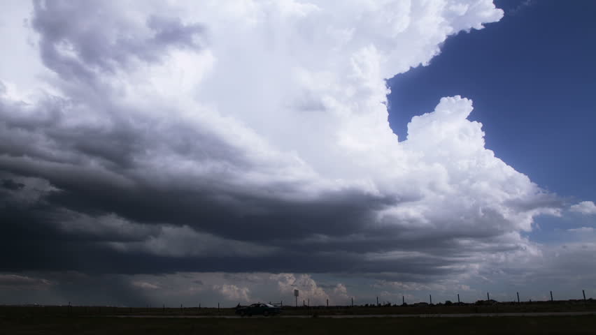 Timelapse of towering cumulonimbus clouds at the edge of a massive,