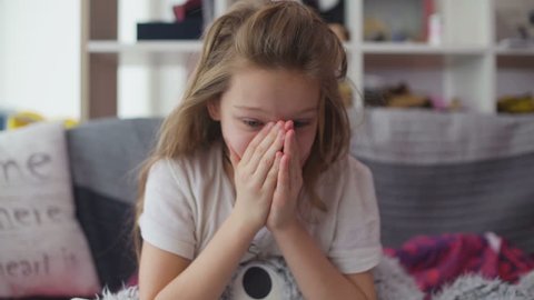 Little girl coughing at home
