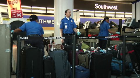 LOS ANGELES - CIRCA 2012: Baggage inspectors at LAX airport during busy travel weekend circa 2012 in Los Angeles, CA.