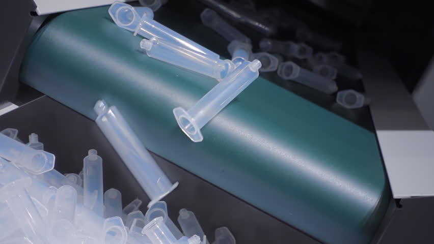 The process of extrusion equipment operation - the movement of different parts - manufacturing disposable plastic products. Slow mo, slow motion, slo mo, high speed camera, 240fps, 250fps