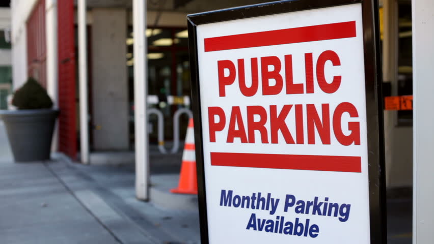 Sign promoting public parking for the garage in the city.