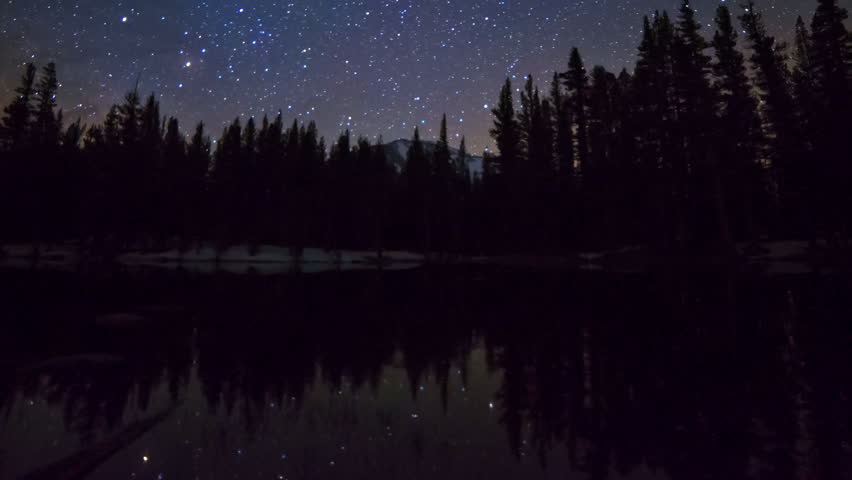 Astrophotography time lapse of milky way galaxy rising over alpine lake reflection in Yosemite National Park, California -Long Shot-