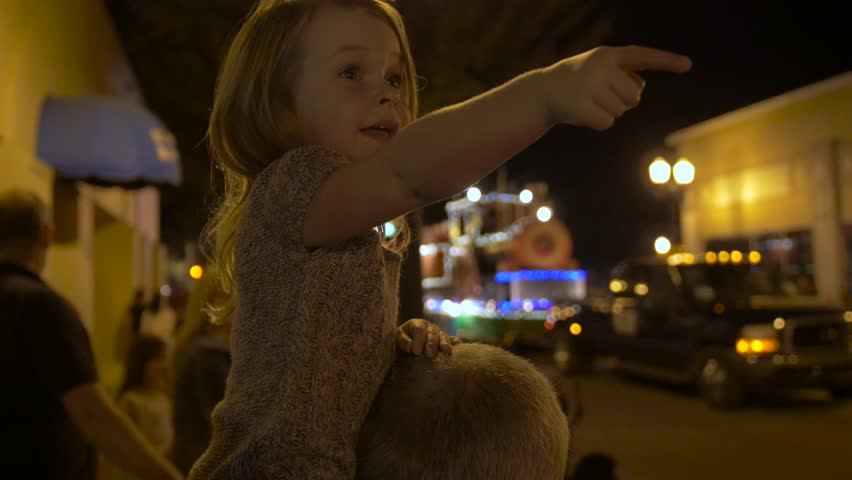 Little Girl Watches Christmas Parade from Dad