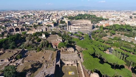 Aerial bird view Italy Rome flying over Domus Severiana moving slowly forwards towards Colosseum extension to imperial palaces Palatine Hill in Roma popular tourist attraction in city center 4k