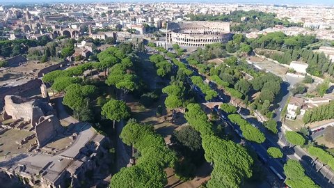 Aerial bird view Italy Rome flying over Domus Severiana moving slowly backwards from Colosseum extension to imperial palaces Palatine Hill in Roma popular tourist attraction in large city center 4k