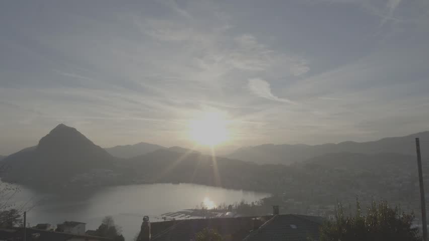 LUGANO, City View During Sunset, Aerial Stock Footage, 4K
A slow pan overlooking the sunset lit city of Lugano, in the Ticino region of Switzerland. 