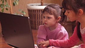 A child at home with a laptop.