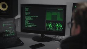 Hacker Company. A hacker is preparing for a cyber-attack. A man at a rapid pace enters information. On monitors the information on the preparations for the hacker attack. - Powered by Shutterstock - Get 15% off with code: PIKWIZARD15