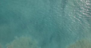 Aerial drone footage of serene sea waves reaching shore, Drone flying over wavy sea.