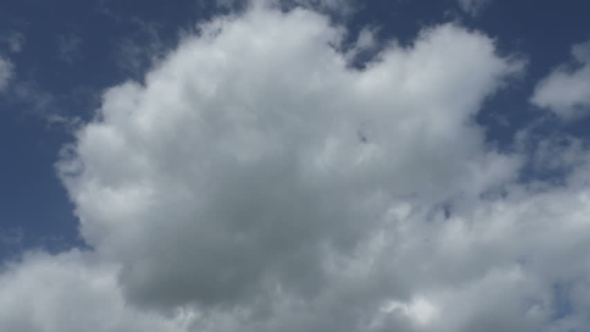 Camera pointing directly up at the sky from a low angle and a little girl jumps over the camera and does a twirl in mid air.