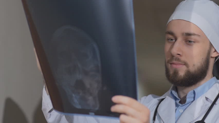 Two doctors consider a patient of x-ray picture