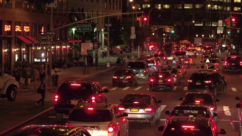NEW YORK, USA - SEPTEMBER 23rd 2016: Accident on busy 6th avenue street in New York City at night. Ambulance van with siren lights on in an emergancy. Cars queued in rows stucked in worst congestion