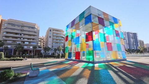 Malaga, Spain - December 15 2016: Colorful glass cube wich is entrance to Centre Pompidou, located in renovated port area of Malaga
