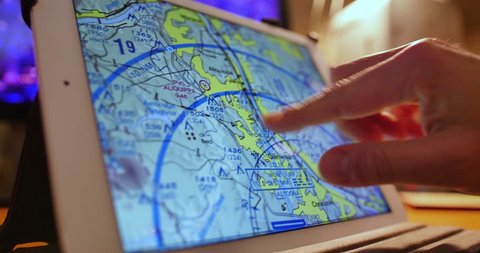 A pilot examines VFR maps of the Pittsburgh area on a tablet PC before a flight.
