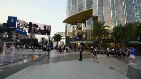 BANGKOK, THAILAND - MARCH 18, 2016: People walking near the Siam Center and Siam Paragon malls. Panning view 