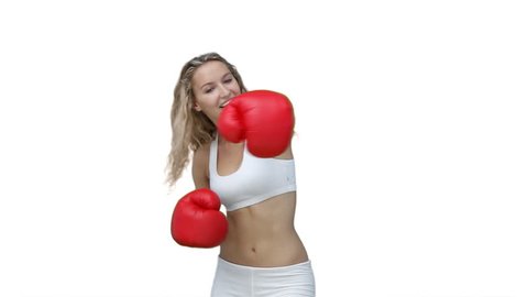 Woman boxing in her training clothes against a white background