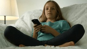 4K Child Watching TV, Girl with Remote Control Relaxing on Sofa, Coach in Living