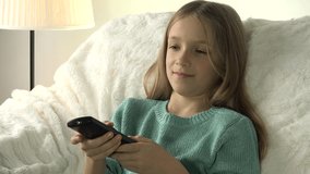 4K Child Watching TV, Girl with Remote Control Relaxing on Sofa, Coach in Living
