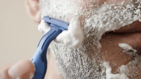Plastic disposable razor shaving beard under chin slow motion 1080p FullHD footage 