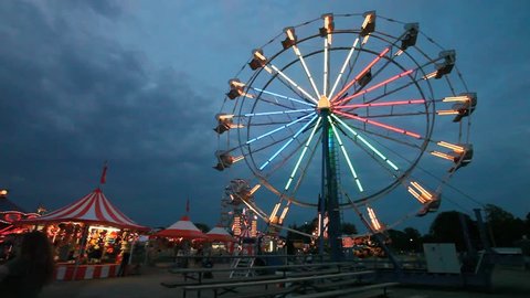 Colorful Ferris wheel with a darkening sky behind
