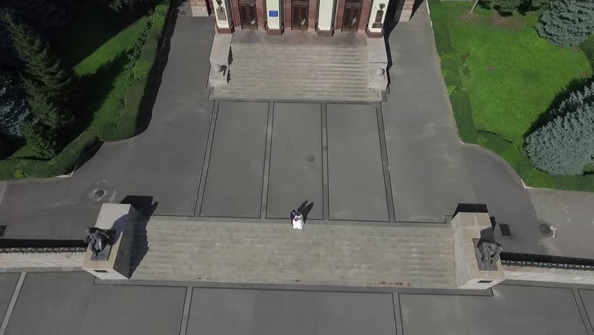 The rise from the bottom to the top of the building from standing at the bottom of the newlyweds. Pan of the building vertically.