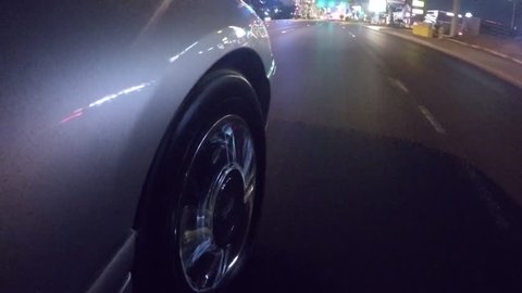 Limo driving the strip in Las Vegas passenger wheel close-up time-lapse shot
