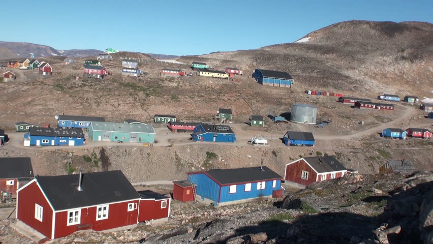 Iceland- 8 September 2016: Houses in the city on the shores of Arctic Ocean in Greenland. General plan. Wilderness. Extreme tourism and travel in the cold polar north. Scenic coastline.