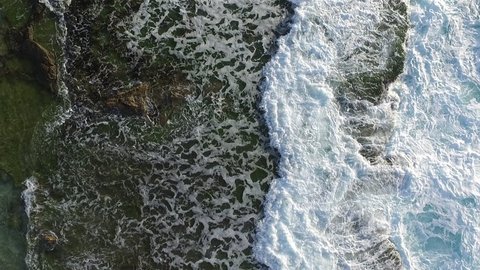 Aerial drone ocean foam water view at the beach waves in the shoreline abstract background