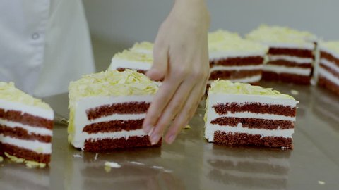 Woman hands cut the slices of cake with the knife