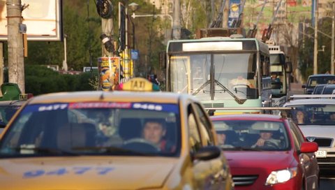 ROMANIA, BUCHAREST – APRIL 16 2016: Trolleybuses struggling to make their way through the rush time traffic of the capital city.