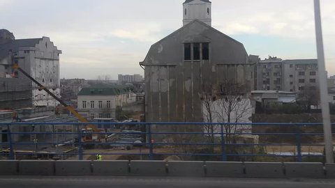 ROMANIA, BUCHAREST – NOVEMBER 16 2016: Historical buildings are being taken over and destroyed by real estate investors. View from Basarab bridge vehicle shot.