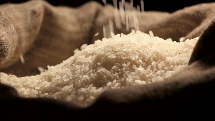 Rice falling in slow motion. Hands and bag of groats. Starch and carbohydrates. Royalty-Free Stock Footage #23954734