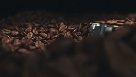Coffee beans in the grinder. Two high quality videos of coffee beans in the grinder. Super slow motion video.