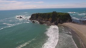 Aerial Video Circling Ocean Rock Formation Near Coastline