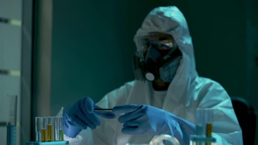Bio engineer hold in arms and use virtual futuristic computer with transparent holographic interface. Rotating animated bio hazard sign in laboratory. Experiments on modified bacteria, virus, gene and Royalty-Free Stock Footage #23975320