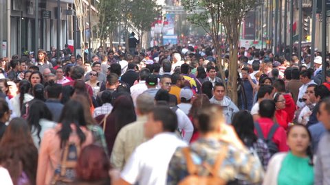 Mexico City, Mexico-CIRCA June,2017 TAKE 2: Crowd walking through street. In Mexico the populatIon growing is a public problem due the high birth rates.