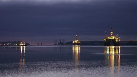 Timelapse of Silhouette of Semi Submersible Oil Rig and Big Boat at Cromarty Firth in Invergordon, Scotland (4K Timelapse)
