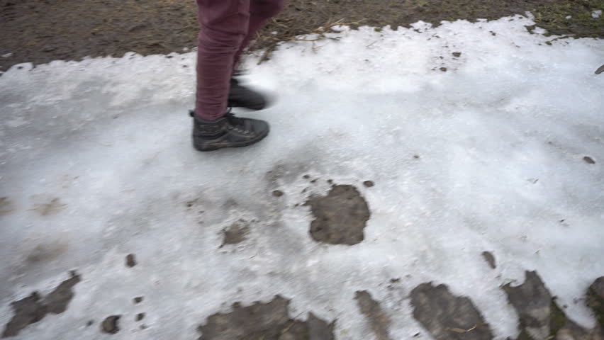 Boy walking on frozen road