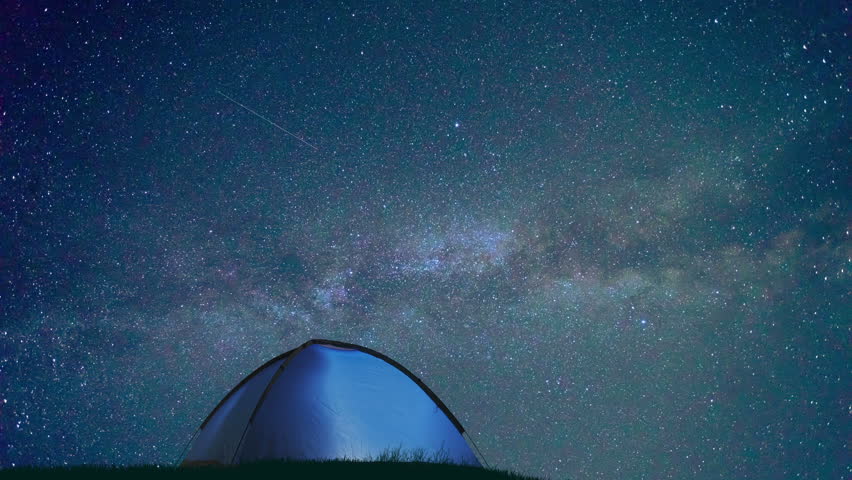 The camping tent against the background of starry sky. Time lapse