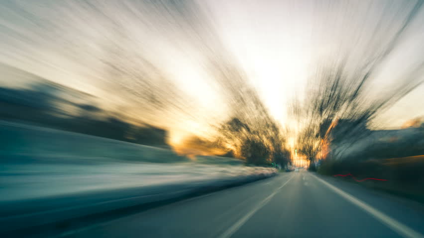 Driving fast on the German Autobahn at sunset, dynamic time lapse video with motion blur 
