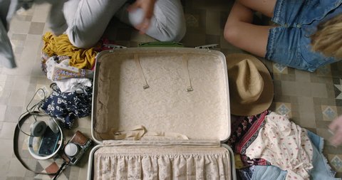 Top view packing vintage suitcase girls planning road trip RED DRAGON: stockvideo