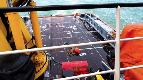 Tug sets anchor and red buoy pipe layer platform
